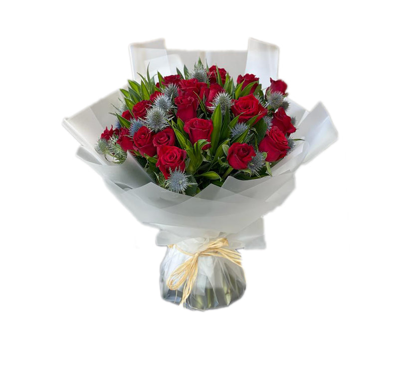 Bouquet of Red roses with and mixed flowers and accessories wrapped in white